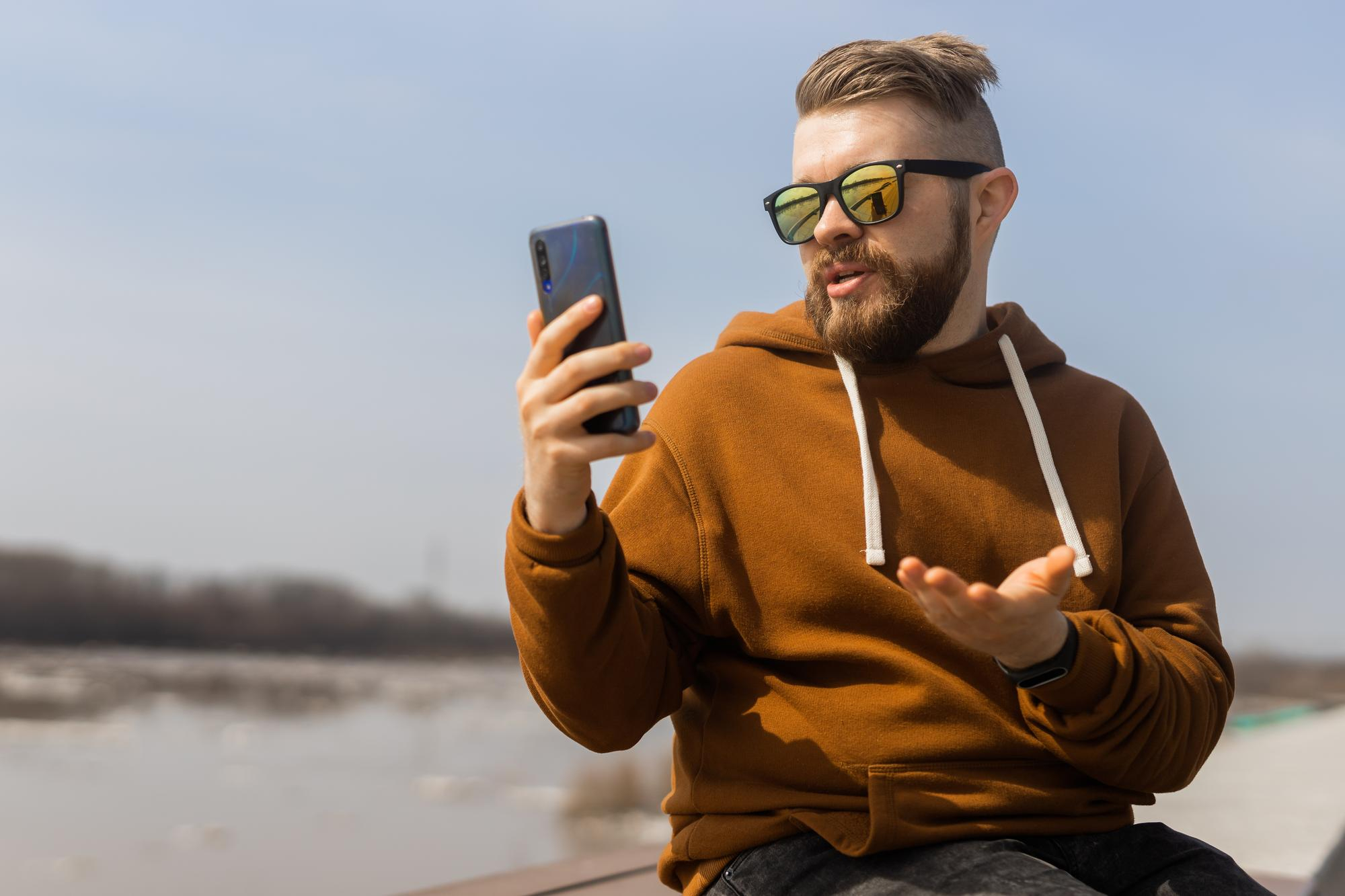 Man using smartphone for telehealth consultation